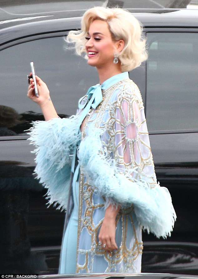 Katy Perry oozes old Hollywood glamour in a feather wrap and blonde wig as she arrives on American Idol set