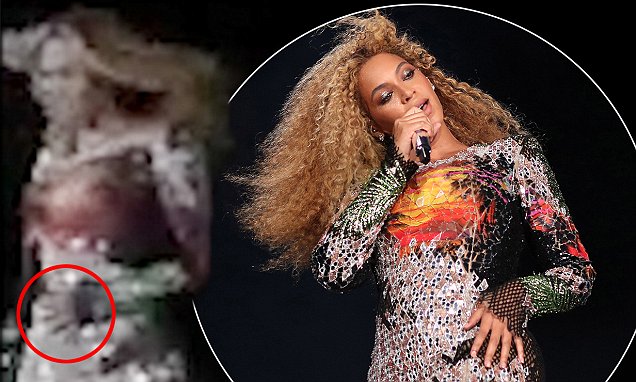 Beyonce cradles her stomach during Performance in Rome Beyonce cradles her stomach during Performance in Rome